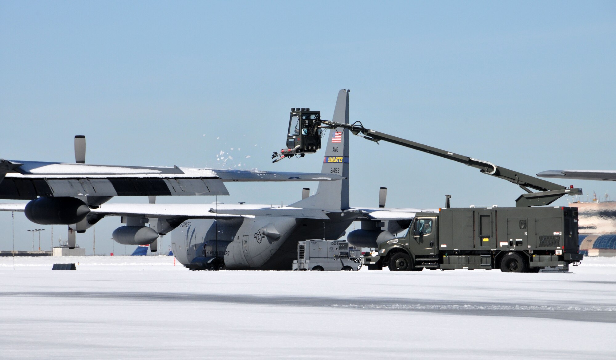 U.S. Air Force Master Sgt. Derek Hastings, 145th Aircraft Maintenance Squadron, starts deicing operations removing snow and ice from 145th Airlift Wing, C-130 Hercules aircraft at the North Carolina Air National Guard base, Charlotte Douglas Intl. airport, February 14, 2014.  The winter storm, which brought over six inches of snow and finished with a blanket of ice, made roads dangerous throughout the entire state and left many households and businesses without power. (U.S. Air National Guard photo by Master Sgt. Patricia F. Moran, 145th Public Affairs/Released)