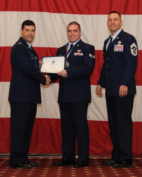 Senior Airman Nathan Posey, 911th Maintenance Squadron, receives an Airman Leadership School graduation certificate from Col. Andrew Gebara, 2nd Bomb Wing commander, on Barksdale Air Force Base, La., Feb. 13, 2014. (U.S. Air Force photo/Senior Airman Joseph A. Pagán Jr.)