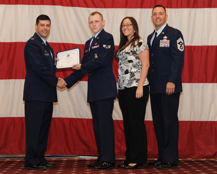 Senior Airman Cody Neale, 2nd Security Forces Squadron, receives an Airman Leadership School graduation certificate from Col. Andrew Gebara, 2nd Bomb Wing commander, on Barksdale Air Force Base, La., Feb. 13, 2014. (U.S. Air Force photo/Senior Airman Joseph A. Pagán Jr.)