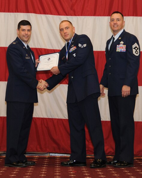 Senior Airman Samuel Jahnke, 2nd Civil Engineer Squadron, receives an Airman Leadership School graduation certificate from Col. Andrew Gebara, 2nd Bomb Wing commander, on Barksdale Air Force Base, La., Feb. 13, 2014. (U.S. Air Force photo/Senior Airman Joseph A. Pagán Jr.)