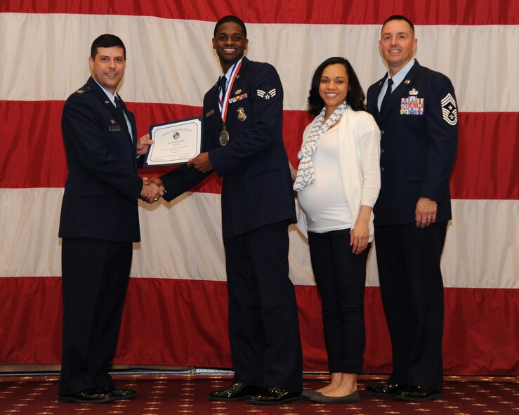 Senior Airman Joshua Hill, 307th Security Forces Squadron, receives an Airman Leadership School graduation certificate from Col. Andrew Gebara, 2nd Bomb Wing commander, on Barksdale Air Force Base, La., Feb. 13, 2014. (U.S. Air Force photo/Senior Airman Joseph A. Pagán Jr.)