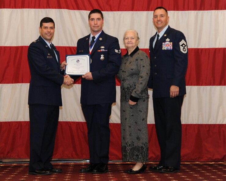 Senior Airman Paul Downs, 307th Security Forces Squadron, receives an Airman Leadership School graduation certificate from Col. Andrew Gebara, 2nd Bomb Wing commander, on Barksdale Air Force Base, La., Feb. 13, 2014. (U.S. Air Force photo/Senior Airman Joseph A. Pagán Jr.)