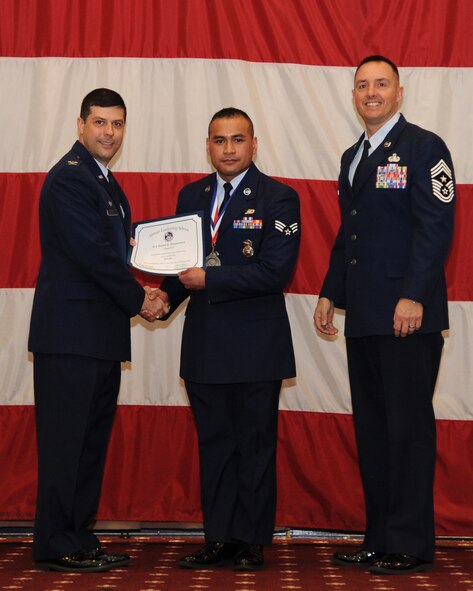 Senior Airman Jezrell Zimmerman, 2nd Security Forces Squadron, receives an Airman Leadership School graduation certificate from Col. Andrew Gebara, 2nd Bomb Wing commander, on Barksdale Air Force Base, La., Feb. 13, 2014. (U.S. Air Force photo/Senior Airman Joseph A. Pagán Jr.)