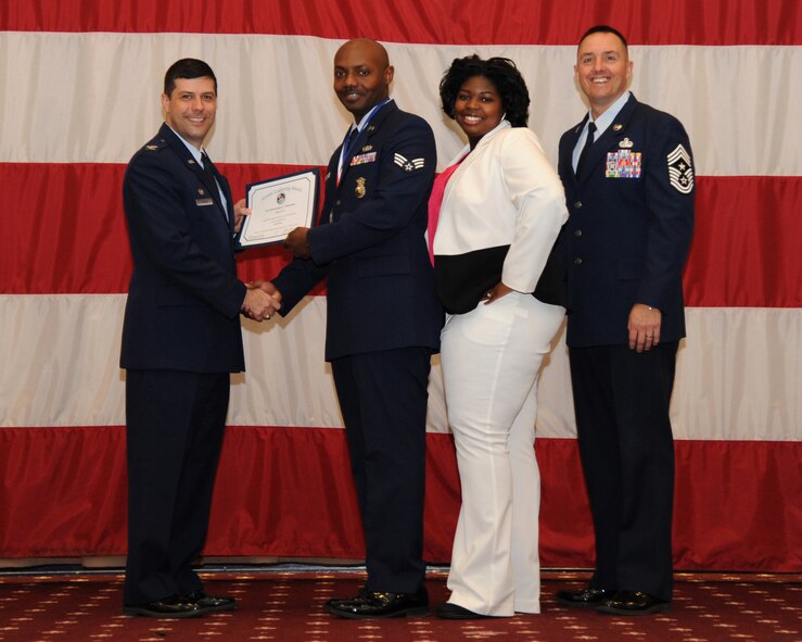 Senior Airman Brandon Peterson, 2nd Security Forces Squadron, receives an Airman Leadership School graduation certificate from Col. Andrew Gebara, 2nd Bomb Wing commander, on Barksdale Air Force Base, La., Feb. 13, 2014. (U.S. Air Force photo/Senior Airman Joseph A. Pagán Jr.)