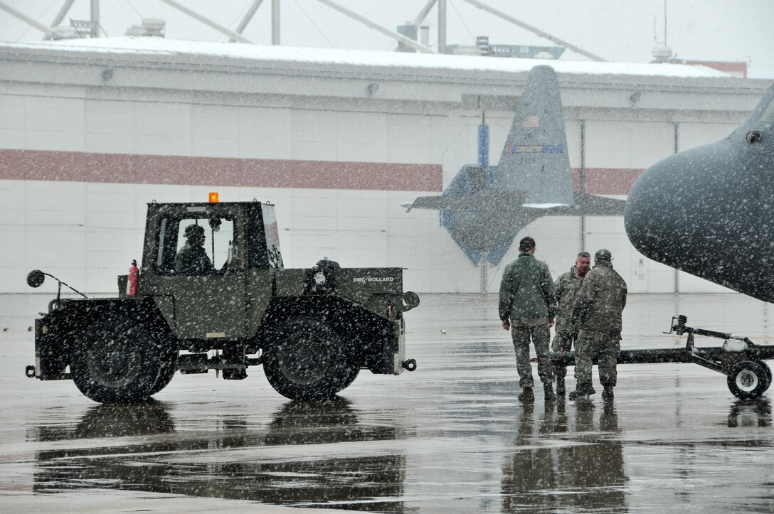 Airmen from the 145th Airlift Wing continue to maintain C-130 Hercules aircraft at the North Carolina Air National Guard base, Charlotte Douglas Intl. airport, February 12, 2014, as the second winter storm of the season hits the Carolinas hard crippling the city of Charlotte under six inches of snow.  During cold and icy conditions members from the 145th Maintenance and Logistic Readiness Squadrons continue maintaining and moving planes and cargo, diligently staying focused on the mission. (U.S. Air National Guard photo by Master Sgt. Patricia F. Moran, 145th Public Affairs/Released)