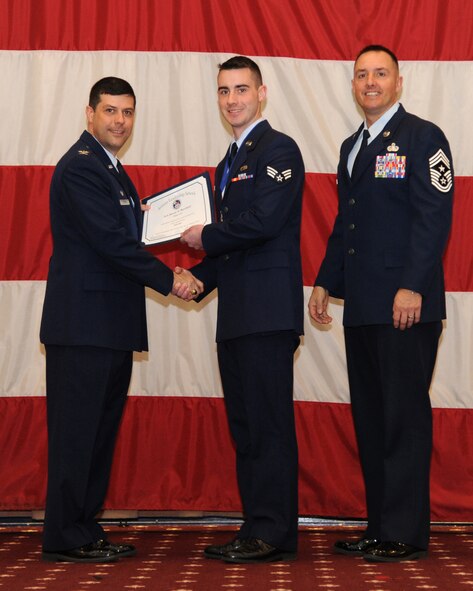 Senior Airman Steven Burchick, 911th Maintenance Squadron, receives an Airman Leadership School graduation certificate from Col. Andrew Gebara, 2nd Bomb Wing commander, on Barksdale Air Force Base, La., Feb. 13, 2014. (U.S. Air Force photo/Senior Airman Joseph A. Pagán Jr.)