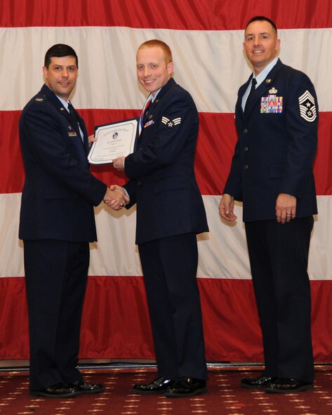 Senior Airman Andy Brown, 2nd Maintenance Squadron, receives an Airman Leadership School graduation certificate from Col. Andrew Gebara, 2nd Bomb Wing commander, on Barksdale Air Force Base, La., Feb. 13, 2014. (U.S. Air Force photo/Senior Airman Joseph A. Pagán Jr.)