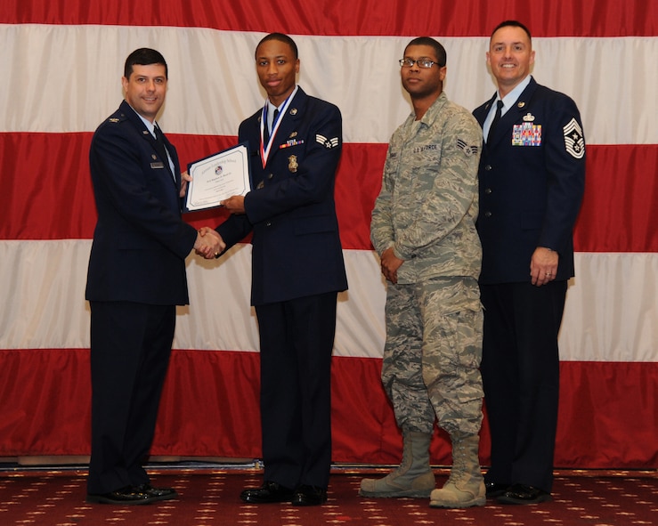 Senior Airman Stephen Boyd Jr., 307th Security Forces Squadron, receives an Airman Leadership School graduation certificate from Col. Andrew Gebara, 2nd Bomb Wing commander, on Barksdale Air Force Base, La., Feb. 13, 2014. (U.S. Air Force photo/Senior Airman Joseph A. Pagán Jr.)