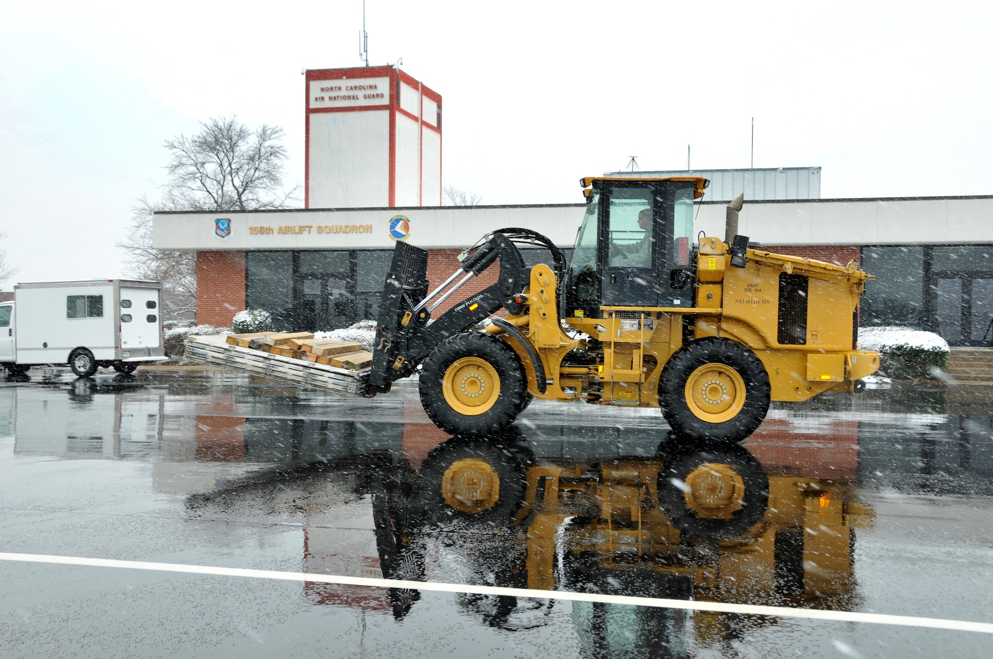 U.S. Air Force Master Sgt. Ricky Tarlton, 145th Logistics Readiness Squadron, Small Air Terminal, operates an all-terrain forklift at the North Carolina Air National Guard base, Charlotte Douglas Intl. airport, February 12, 2014 during a winter storm that brought the city to a standstill. Tarlton pressed on relocating aircraft pallets to a staging area where medical supplies will be palletized for transporting on a 145th Airlift Wing, C-130 Hercules aircraft.(U.S. Air National Guard photo by Master Sgt. Patricia F. Moran, 145th Public Affairs/Released)