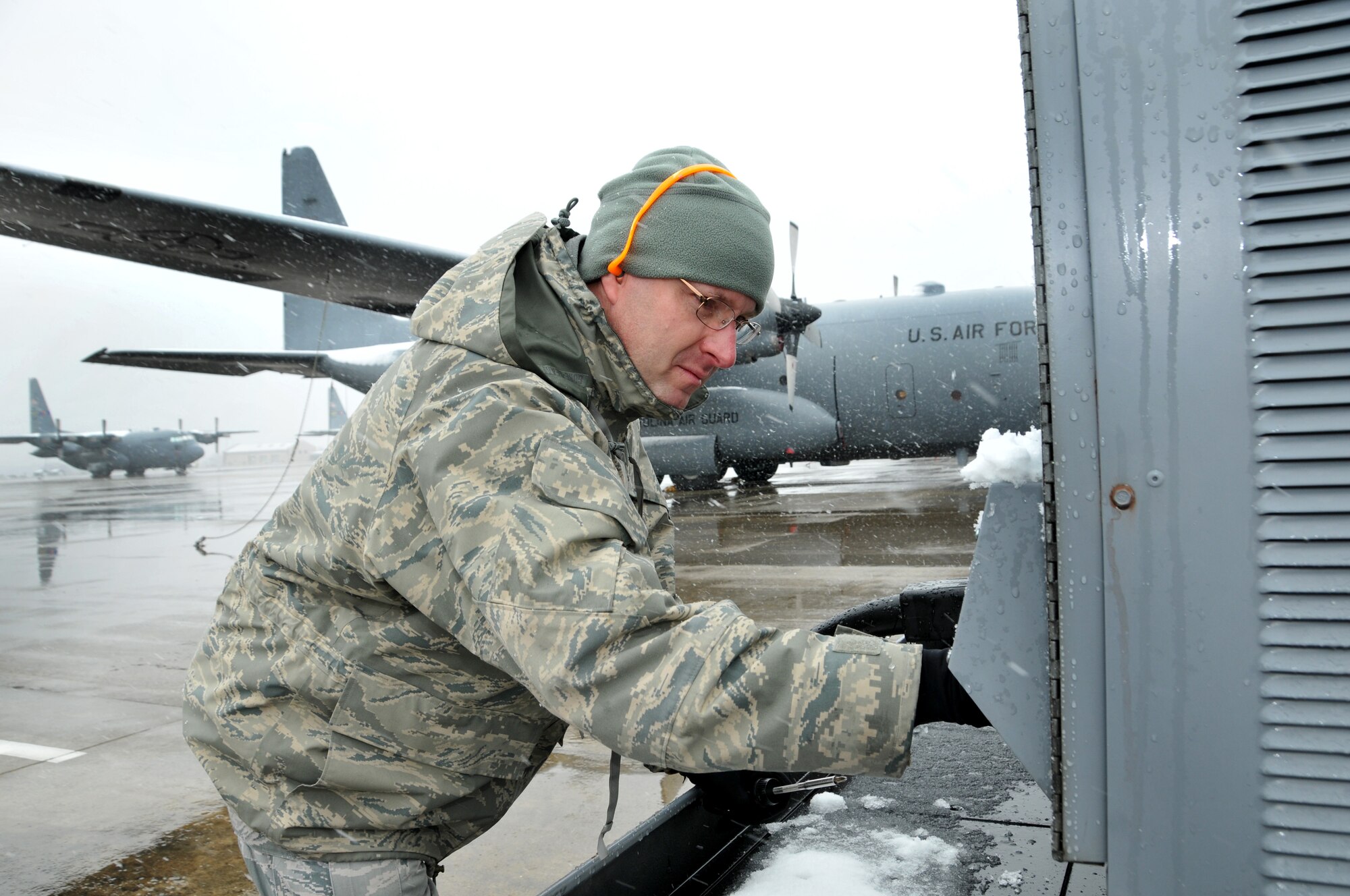 U.S. Air Force Master Sgt. Dennis Heidenfeldt, 145th Maintenance Squadron, communication and navigation specialist, starts up a power unit providing power to a waiting C-130 Hercules aircraft at the North Carolina Air National Guard base, Charlotte Douglas Intl. airport, February 12, 2014.   During a snowstorm that crippled the city and cancelled many flights, Heidenfeldt worked with contractors installing Real Time In Cockpit (RTIC) unit which enhances and integrates a situ¬ational awareness (SA) capability that allows aircrews to commu¬nicate with ground crews during airlift, airdrop, and other opera¬tions.  (U.S. Air National Guard photo by Master Sgt. Patricia F. Moran, 145th Public Affairs/Released)