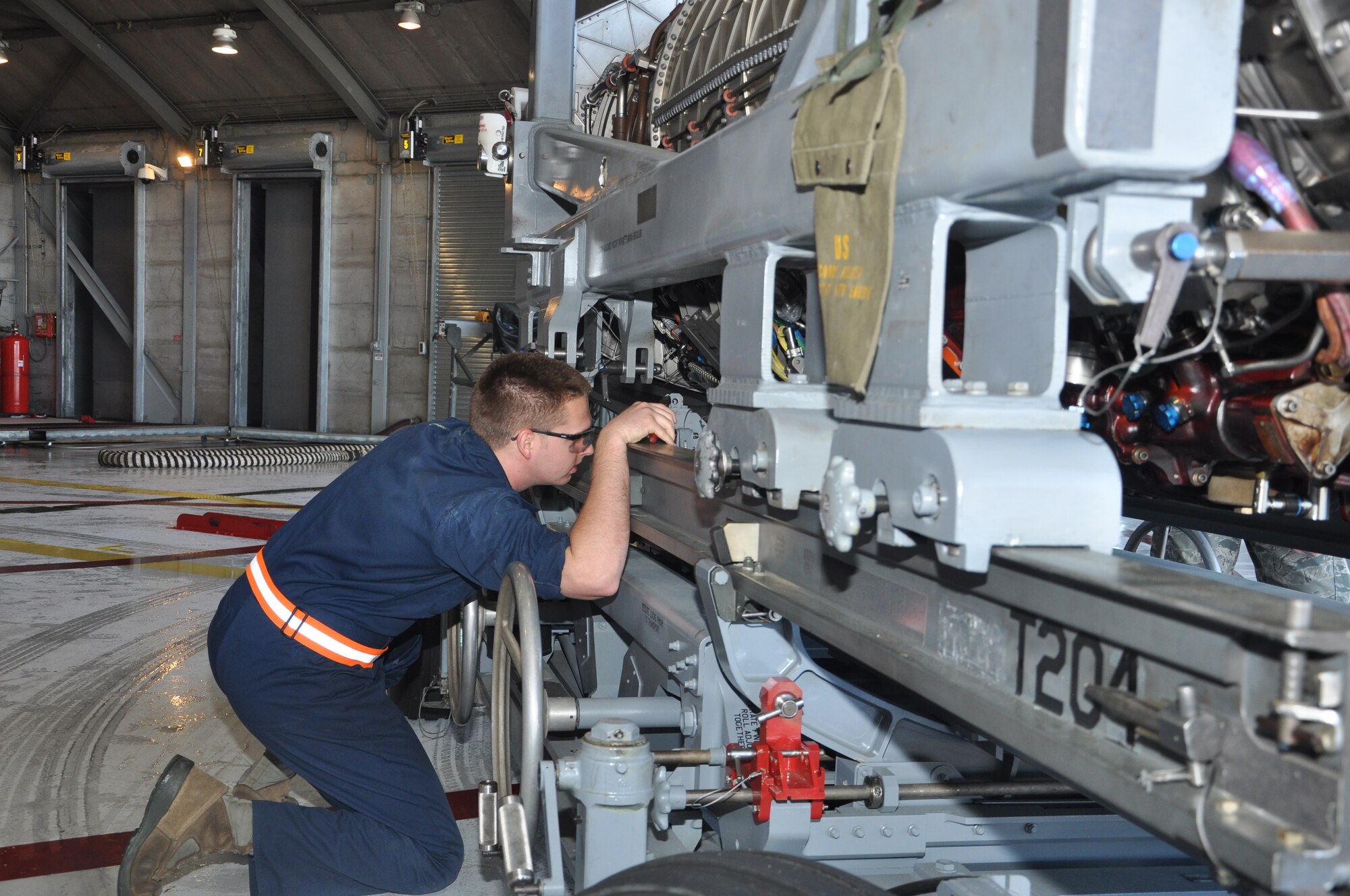 Airman 1st Class Dwayne Traynor, 325th Maintenance Squadron aerospace propulsion technician, checks F-22 Raptor’s F-119 engine before it is set in an M-37 T-20 engine test stand Feb. 20 at the Test Cell. This process takes before the engine is moved from its trailer to the test stand.  (U.S. Air Force photo by Airman 1st Class Solomon Cook)