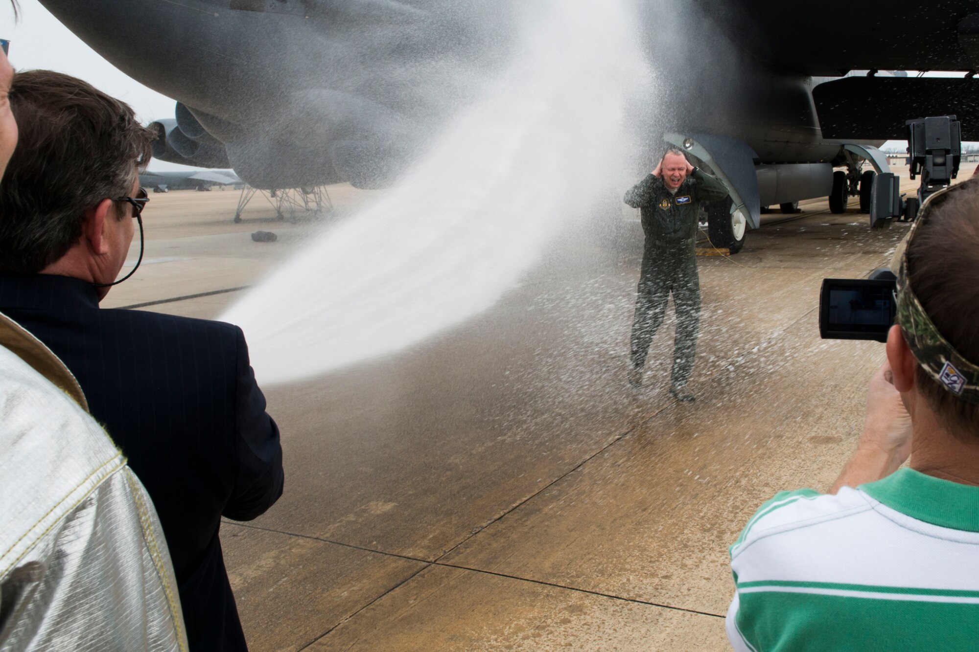 U.S. Air Force Col. Joseph Jones, 307th Bomb Wing vice commander, is hosed down after returning from a mission in a B-52H Stratofortress, Feb. 18, 2014, Barksdale Air Force Base, La. The mission consisted of two B-52s with aircrews totaling over 100,000 flying hours and was also the last flight for Jones, who is retiring from the Air Force Reserve. (U.S. Air Force photo by Master Sgt. Greg Steele/Released)