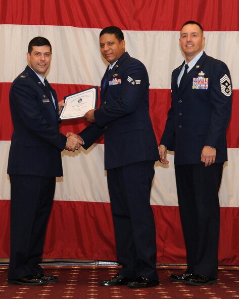 Senior Airman Michael Boucher Jr., 302nd Aircraft Maintenance Squadron, receives an Airman Leadership School graduation certificate from Col. Andrew Gebara, 2nd Bomb Wing commander, on Barksdale Air Force Base, La., Feb. 13, 2014. (U.S. Air Force photo/Senior Airman Joseph A. Pagán Jr.)