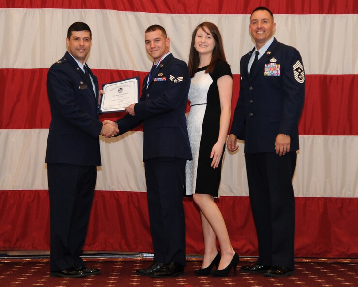 Senior Airman Anthony Stafford, 2nd Maintenance Squadron, receives an Airman Leadership School graduation certificate from Col. Andrew Gebara, 2nd Bomb Wing commander, on Barksdale Air Force Base, La., Feb. 13, 2014. (U.S. Air Force photo/Senior Airman Joseph A. Pagán Jr.)