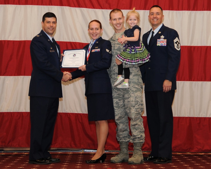 Senior Airman Alicia Freedman, 2nd Operations Support Squadron, receives an Airman Leadership School graduation certificate from Col. Andrew Gebara, 2nd Bomb Wing commander, on Barksdale Air Force Base, La., Feb. 13, 2014. (U.S. Air Force photo/Senior Airman Joseph A. Pagán Jr.)
