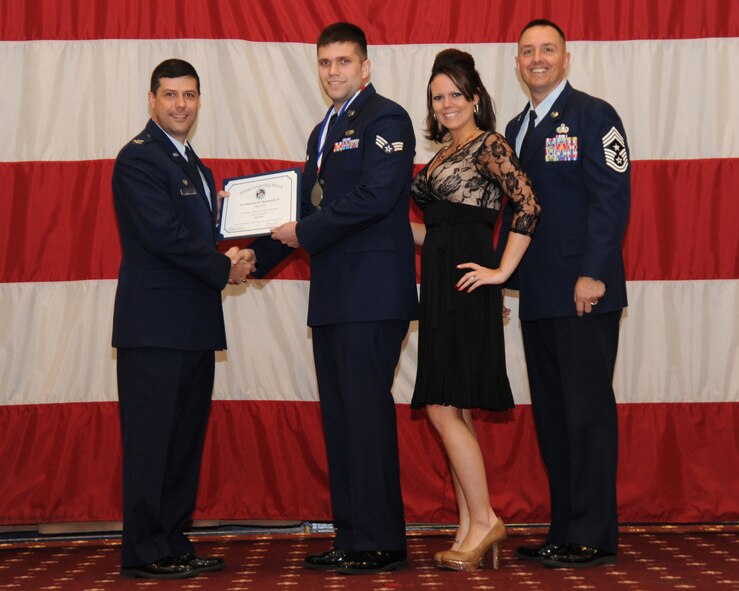 Senior Airman Michael Romanyak Jr., 2nd Maintenance Group, receives an Airman Leadership School graduation certificate from Col. Andrew Gebara, 2nd Bomb Wing commander, on Barksdale Air Force Base, La., Feb. 13, 2014. (U.S. Air Force photo/Senior Airman Joseph A. Pagán Jr.)
