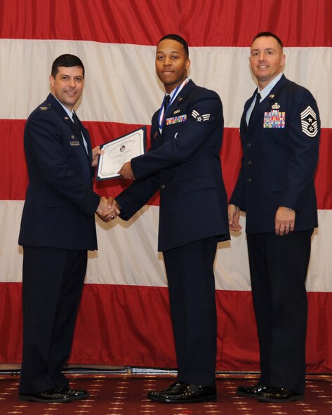 Senior Airman Devonte Robinson, 2nd Logistics Readiness Squadron, receives an Airman Leadership School graduation certificate from Col. Andrew Gebara, 2nd Bomb Wing commander, on Barksdale Air Force Base, La., Feb. 13, 2014. (U.S. Air Force photo/Senior Airman Joseph A. Pagán Jr.)