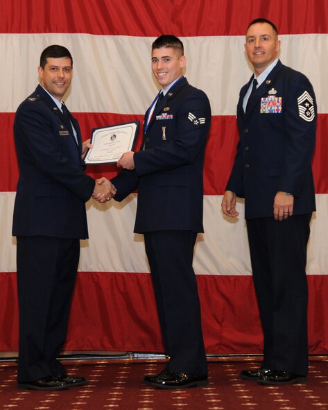 Senior Airman Caleb Nolan, 2nd Aircraft Maintenance Squadron, receives an Airman Leadership School graduation certificate from Col. Andrew Gebara, 2nd Bomb Wing commander, on Barksdale Air Force Base, La., Feb. 13, 2014. (U.S. Air Force photo/Senior Airman Joseph A. Pagán Jr.)