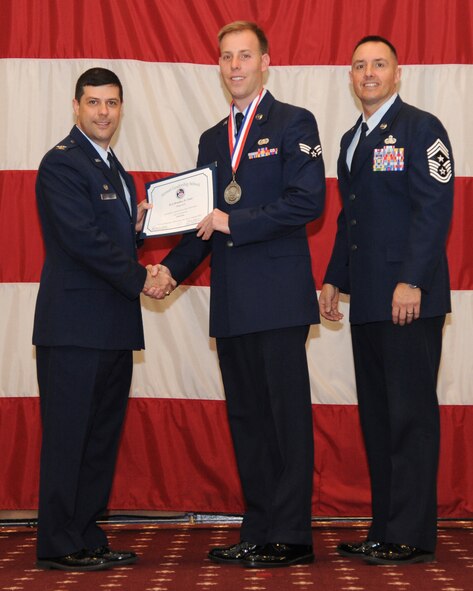 Senior Airman Bradley Clott, 2nd Operations Support Squadron, receives an Airman Leadership School graduation certificate from Col. Andrew Gebara, 2nd Bomb Wing commander, on Barksdale Air Force Base, La., Feb. 13, 2014. (U.S. Air Force photo/Senior Airman Joseph A. Pagán Jr.)