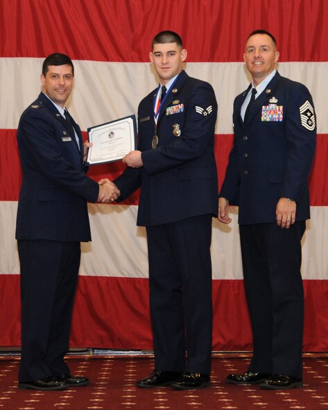 Senior Airman Alexander Costanzo, 2nd Security Forces Squadron, receives an Airman Leadership School graduation certificate from Col. Andrew Gebara, 2nd Bomb Wing commander, on Barksdale Air Force Base, La., Feb. 13, 2014. (U.S. Air Force photo/Senior Airman Joseph A. Pagán Jr.)
