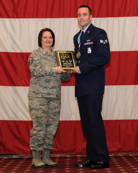 Senior Airman Justin Hatch, 2nd Civil Engineer Squadron, receives the Distinguished Graduate Award from Master Sgt. Joelle Silny, Air Force Global Strike Command, on behalf of the Air Force Sergeants Association during the Airman Leadership School class 14-2 graduation on Barksdale Air Force Base, La., Feb. 13, 2014. (U.S. Air Force photo/Senior Airman Joseph A. Pagán Jr.)