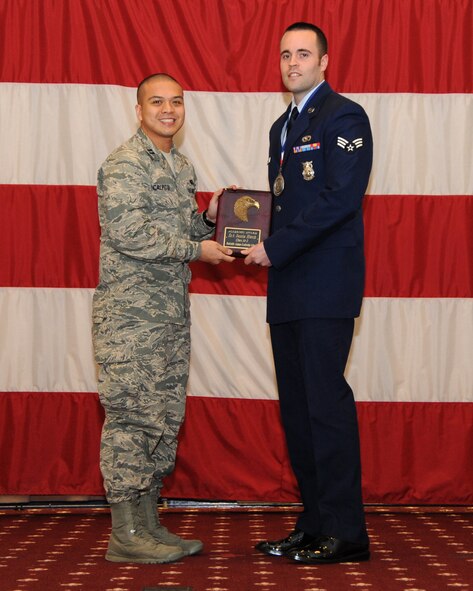 Senior Airman Justin Hatch, 2nd Civil Engineer Squadron, receives the Academic Award from Capt. Janray Calpito, 2nd Force Support Squadron, during the Airman Leadership School class 14-2 graduation on Barksdale Air Force Base, La., Feb. 13, 2014. (U.S. Air Force photo/Senior Airman Joseph A. Pagán Jr.)