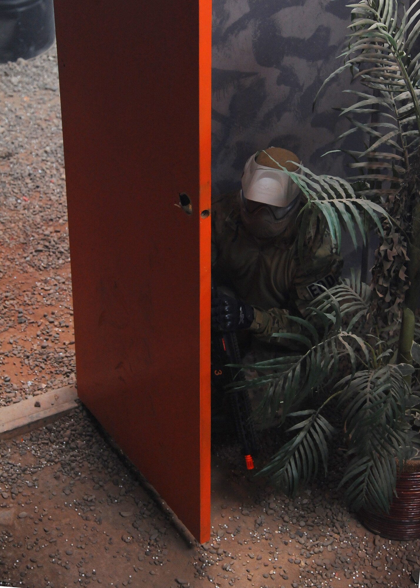 Airman 1st Class Randy Shandler, 341st Civil Engineer Squadron Explosive Ordnance Disposal technician, waits behind a door for an opponent during a tactical training exercise at the Electric City Airsoft range Feb. 14. During the training, the players in the airsoft arena had a chance to participate in a little healthy competition between each other. (U.S. Air Force photo/Senior Airman Cortney Paxton)