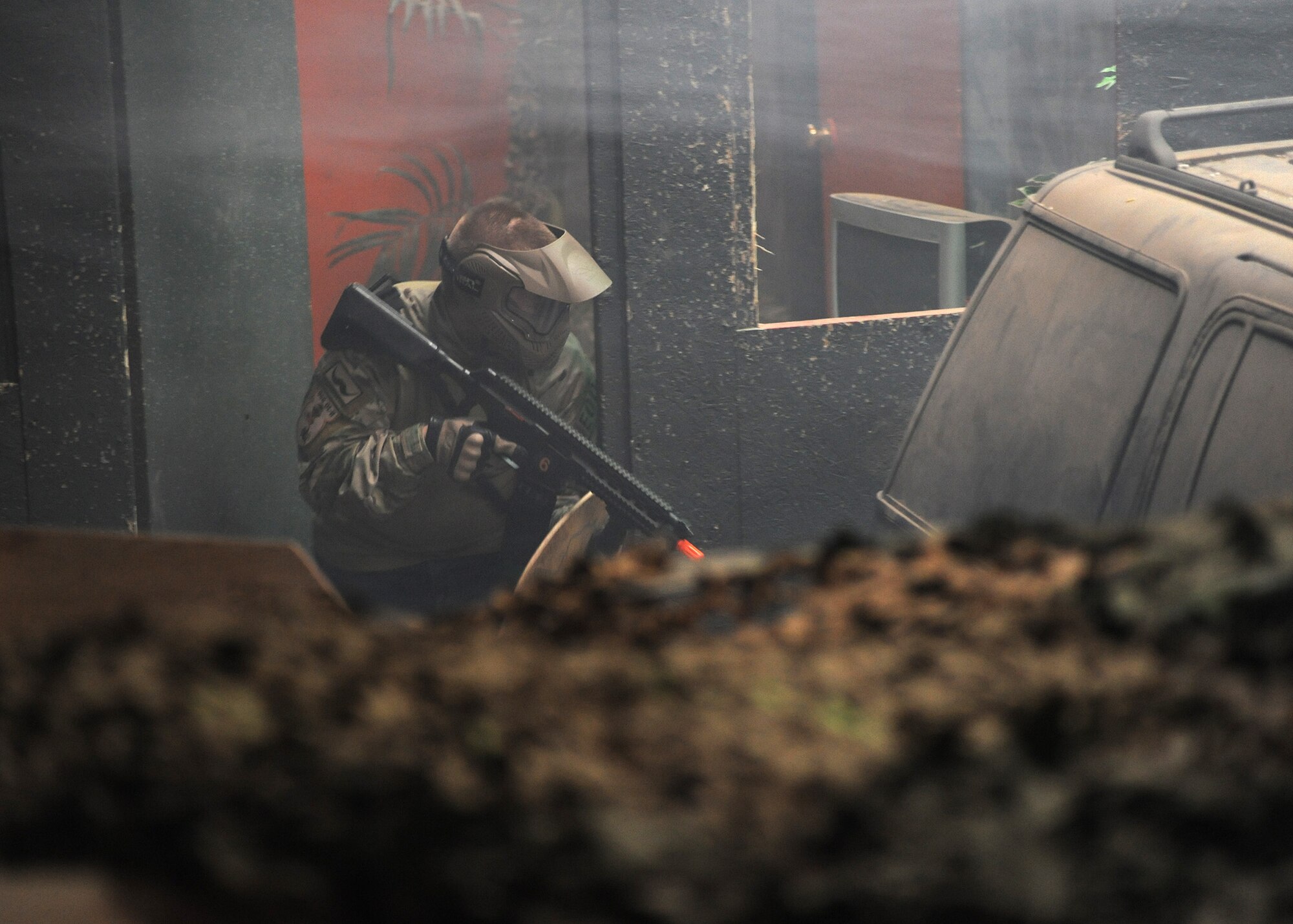 Senior Airman Michael Muck, 341st Civil Engineer Squadron Explosive Ordnance Disposal technician, sneaks behind a prop at the Electric City Airsoft range looking for opponents during an airsoft tournament Feb. 14. The tournament was used as tactical training for Malmstrom’s EOD and Emergency Management team members. (U.S. Air Force photo/Airman 1st Class Joshua Smoot)