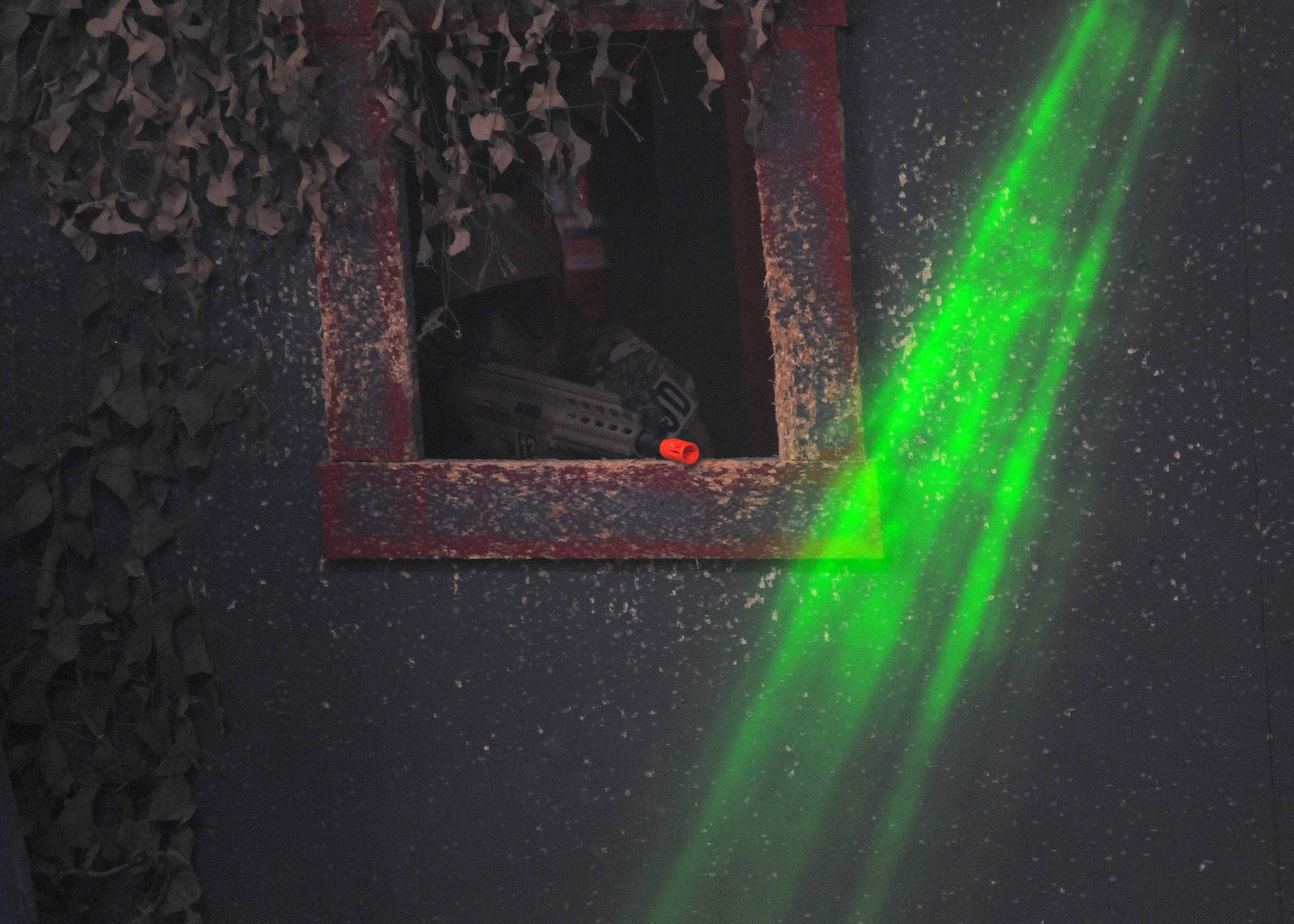 Airman 1st Class Richard Emery II, 341st Civil Engineer Squadron Explosive Ordnance Disposal technician, scans for opponents during a tactical training exercise at the Electric City Airsoft range Feb. 14. Lights, smoke and loud sounds filled the arena to add to the tactical training, giving the participants a sense of a down-range scenario. (U.S. Air Force photo/Airman 1st Class Joshua Smoot)