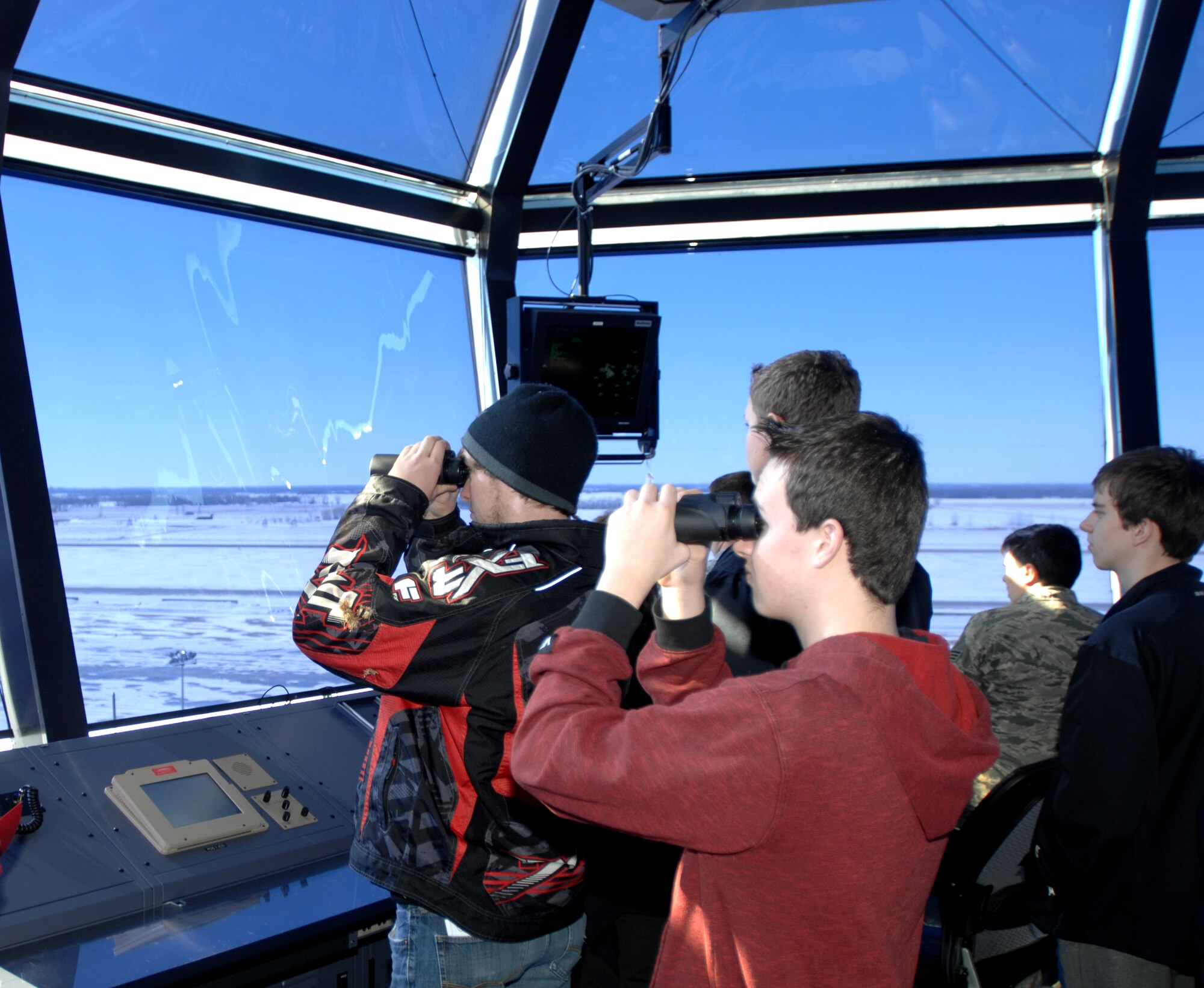 Students from four local high schools tour the 319th Operations Support Squadron Radar Approach and Control Tower overlooking the runway Feb. 18, 2014, on Grand Forks Air Force Base, N.D. More than three dozen students visited the base to learn about possible careers in the military in observance of National Job Shadow Month. (U.S. Air Force photo/Staff Sgt. Susan L. Davis)