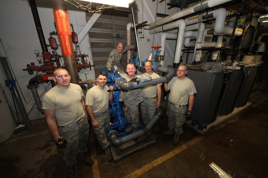 During this special joint project members from the Air Force Reserve and active duty spent time  training together.  The 375 CES operations flight worked with members from the 932 CES operations flight to install a 4" duplex domestic water booster pump, 3" isolation valve, and rebuild a 4" backflow preventer. During the course of this project material costs were $39,923.83 (pumps and piping material) and they spent 104 man hours (contractor install would have been $115,000 for labor alone according to CE.
- 3 job specialties contributed to this  project ( WFSM, Electrical, & HVAC)
- We installed approx. 20' of new 4" schedule 80 PVC water lines.
"We were able to provide training to Airmen in 5 and 7 level upgrade training. Seen here are:  Left to right: Senior Airman Murphy; Master Sgt. Tripp; Master Sgt. Presser; Tech Sgt. Griffith; Tech Sgt. Engelke and in the back row Staff Sgt. Frank all stand at the ready to work," said Senior Master Sgt. Ron Peterson fromt he 932nd CE office  (U.S. Air Force photo/Tech Sgt. Christopher Parr)  