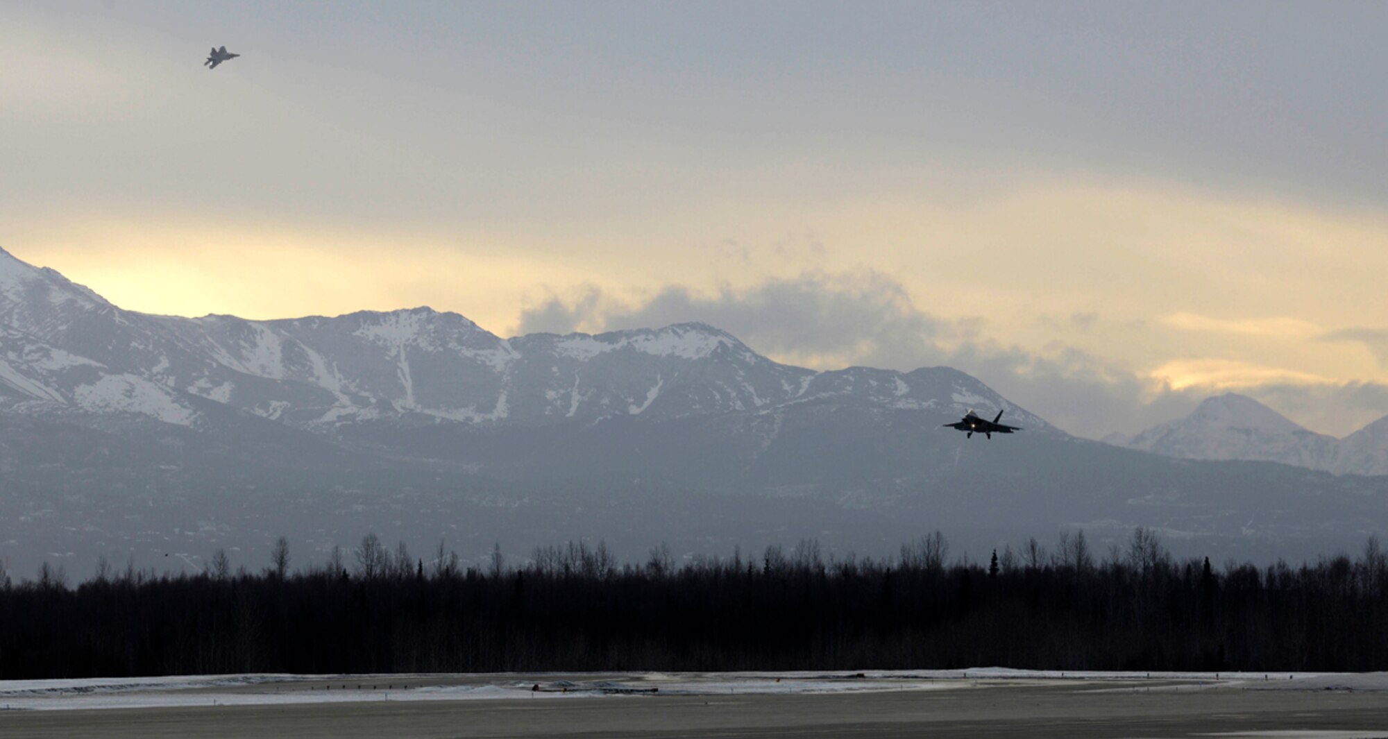 F-22 Raptors assigned to the 90th Fighter Squadron prepare to land on Joint Base Elmendorf-Richardson, Alaska, during a Rapid Raptor scenario in Exercise Polar Force 14-2, Feb. 10, 2014. During the exercise, the 3rd Wing practiced the new rapid raptor strategy that will enable combat-ready F-22s to rapidly refuel, rearm and redeploy. (U.S. Air Force photo/Staff Sgt. Sheila deVera)