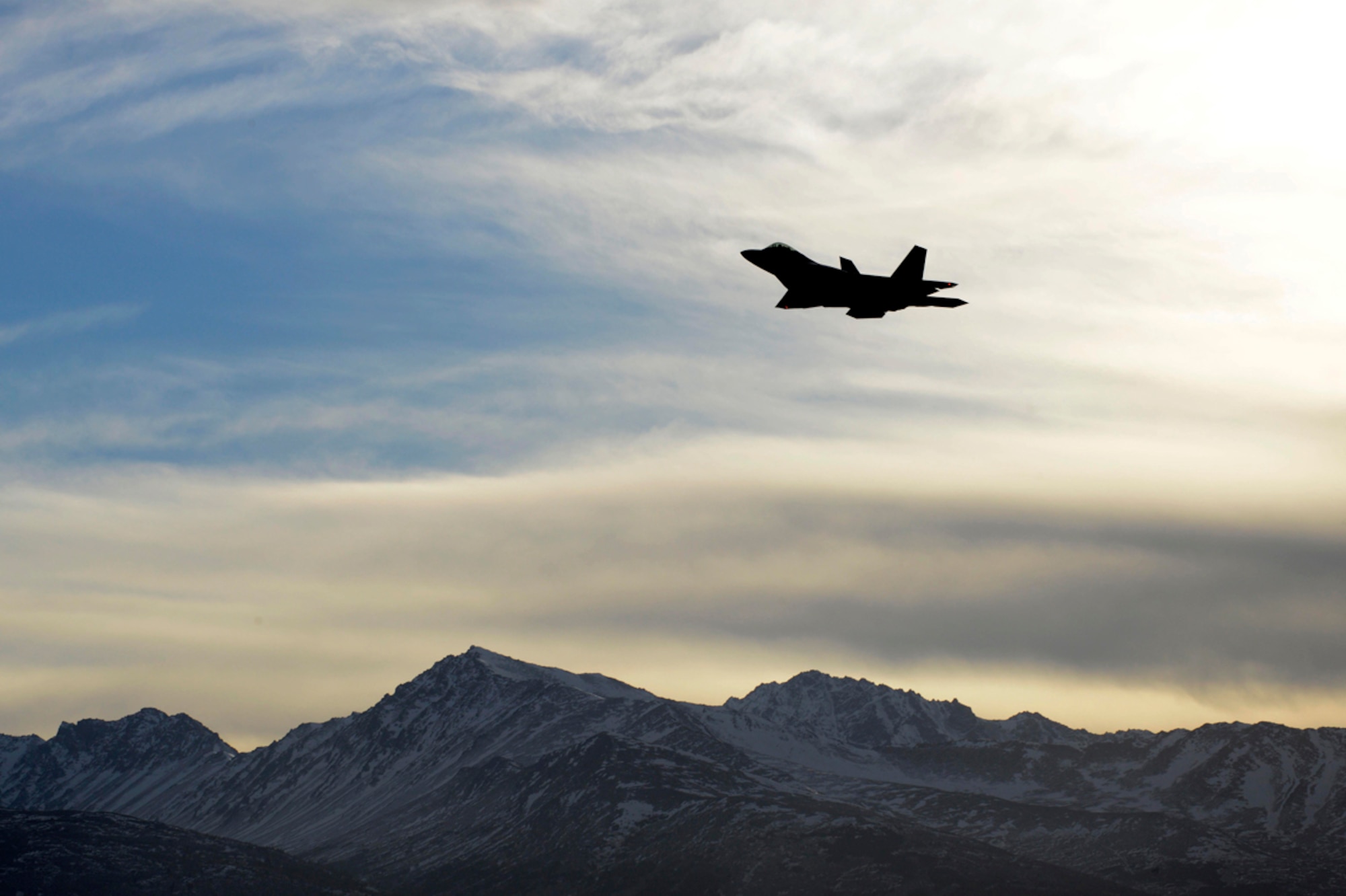 An F-22 Raptor flies over Joint Base Elmendorf-Richardson, Alaska during Exercise Polar Force 14-2, Feb. 10, 2014. The exercise is designed to validate JBER’s ability to integrate, mobilize and prepare assigned personnel, aircraft and equipment for a wartime mission. (U.S. Air Force photo/Staff Sgt. Sheila deVera)