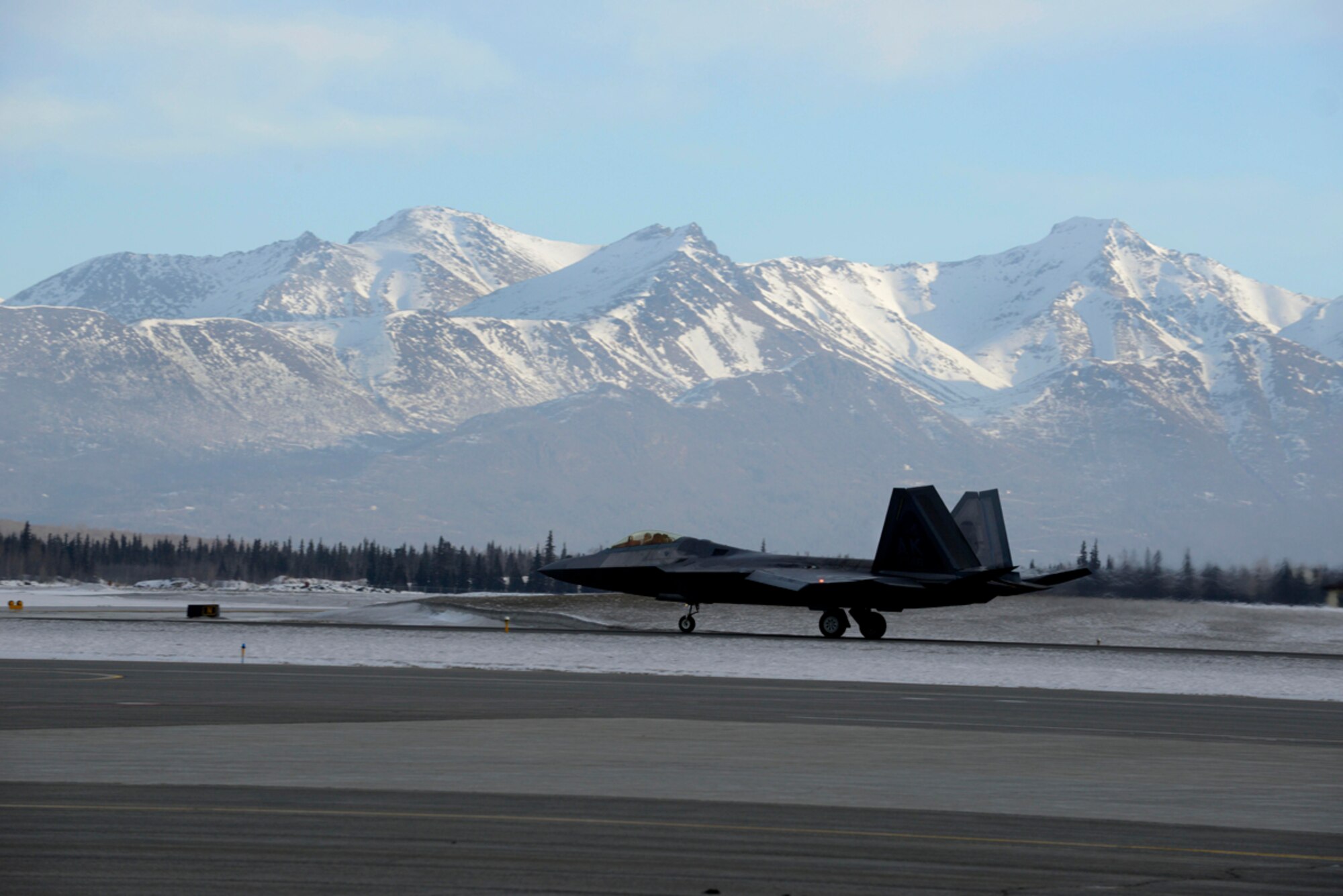 An F-22 Raptor assigned to the 90th Fighter Squadron lands on Joint Base Elmendorf-Richardson, Alaska, during a rapid raptor scenario during Exercise Polar Force 14-2, Feb. 10, 2014. During the exercise, the 3rd Wing practiced the new Rapid Raptor strategy that will enable combat-ready F-22s to rapidly refuel, rearm and redeploy. (U.S. Air Force photo/Staff Sgt. Sheila deVera)