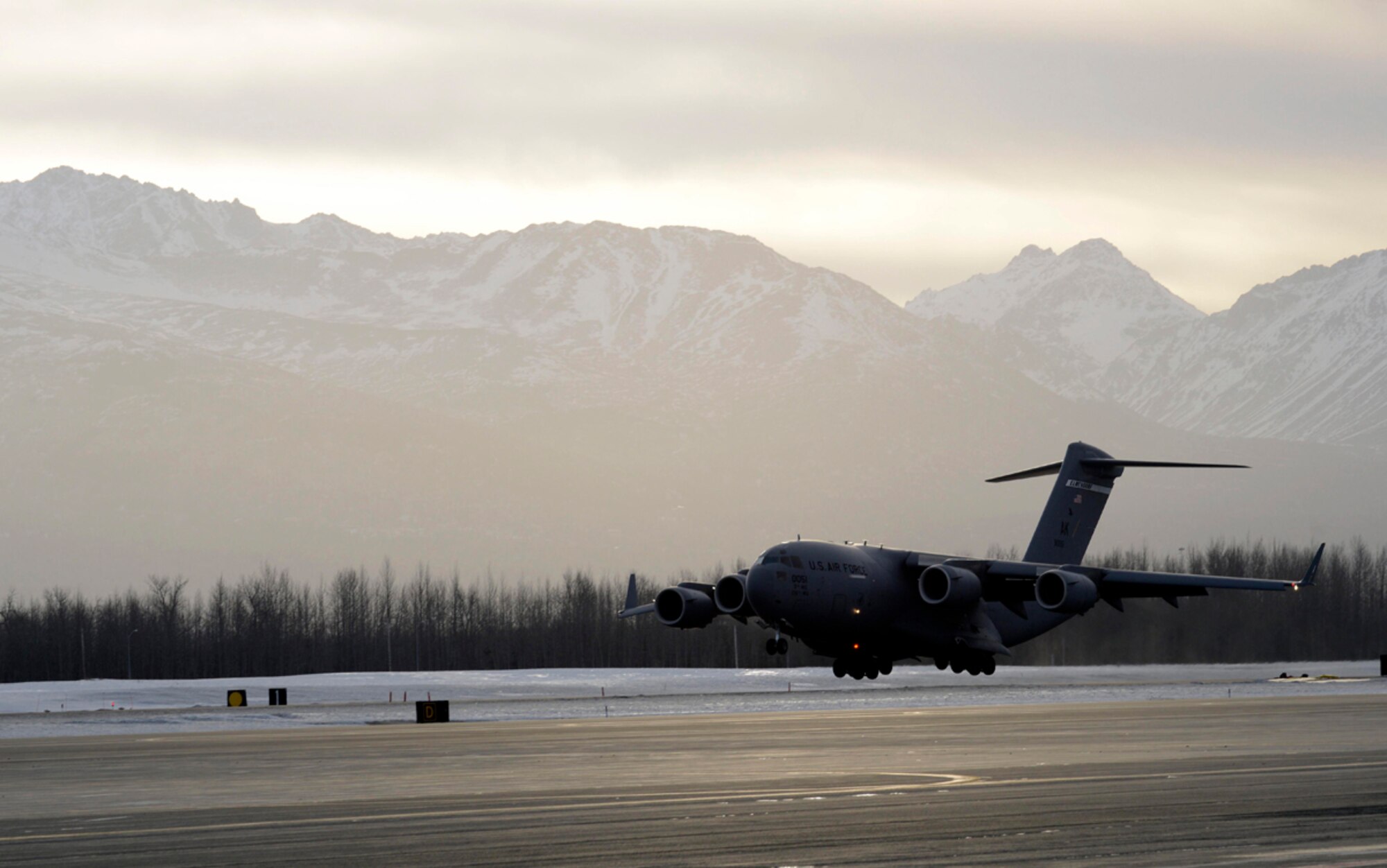 A C-17 Globemaster III assigned to the 517th Airlift Squadron lands during exercise Polar Force 14-2 on Joint Base Elmendorf-Richardson, Alaska, Feb. 10, 2014. The 517th AS provides tactical airlift operations to support worldwide airlift, airdrop, and airland requirements while providing airlift for theater deployed forces and resupply of remote Alaskan long-range radar sites. (U.S. Air Force photo/Staff Sgt. Sheila deVera)