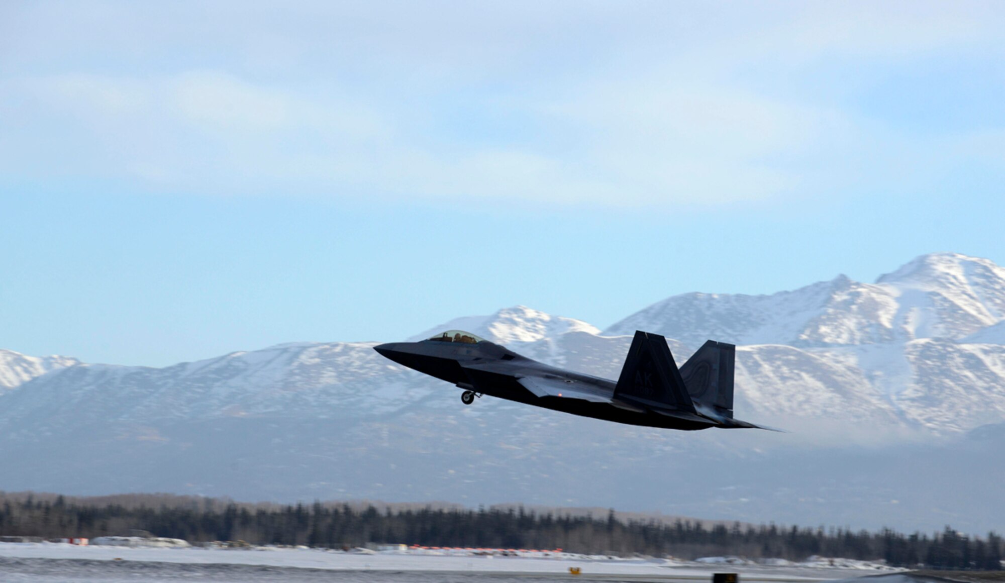 An F-22 Raptor assigned to the 90th Fighter Squadron takes off on Joint Base Elmendorf-Richardson, Alaska, Feb. 10, 2014, during Exercise Polar Force 14-2. During the exercise, the 3rd Wing practiced the new rapid raptor strategy that will enable combat-ready F-22s to rapidly refuel, rearm and redeploy. (U.S. Air Force photo/Staff Sgt. Sheila deVera)