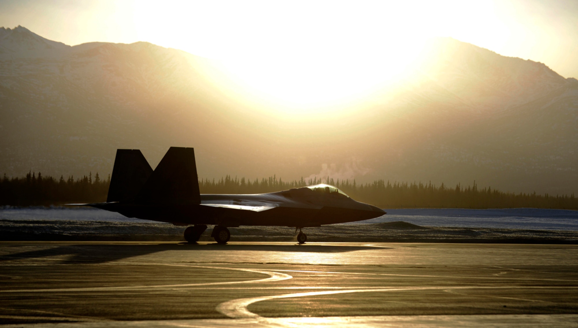 An F-22 Raptor assigned to the 90th Fighter Squadron taxis on the runway during Exercise Polar Force 14-2 on Joint Base Elmendorf-Richardson, Alaska, Feb. 10, 2014. The exercise is designed to validate JBER’s ability to integrate, mobilize and prepare assigned personnel, aircraft and equipment for a wartime mission. (U.S. Air Force photo/Staff Sgt. Sheila deVera)
