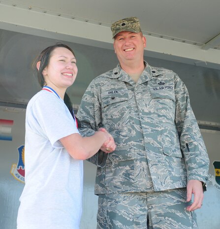 Airman 1st Class Abby Staude (left), receives a medal from Lt. Col. Kenneth Uhler, 9th Mission Support Group deputy commander, at Beale Air Force Base, Calif., Feb. 20, 2014. Staude was the fastest woman during a Recce Challenge Adventure Series 10K run with a time of 54 minutes, 58 seconds. (U.S. Air Force photo by Airman 1st Class Bobby Cummings/Released)
