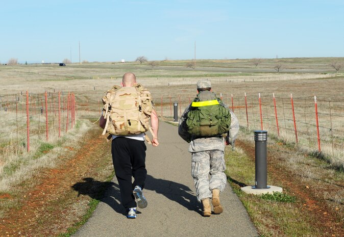 Senior Airman Nick Akley (left), and Staff Sgt. Oscar Vargas, run a 10K with 40-pound rucksacks at Beale Air Force Base, Calif., Feb. 20, 2014. Both men were participants in the Recce Challenge Adventure Series 10K run. (U.S. Air Force photo by Airman 1st Class Bobby Cummings/Released)