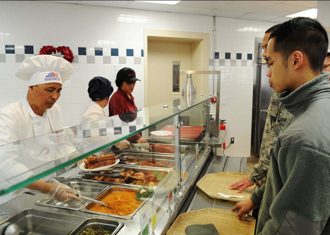Freedom Hall Dining Facility personnel serve food during lunch service at Joint Base Andrews, Md., Feb. 14. The 58th Annual Hennessy Trophy Awards Program Competition grades facilities on categories including; kitchen operations, serving and dining, training and sanitation and maintenance.  (U.S. Air Force photo/Staff Sgt. Nichelle Anderson)