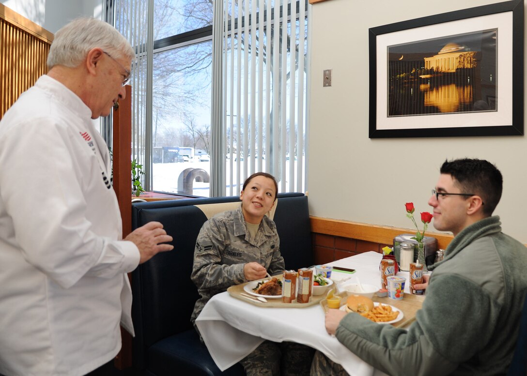 Joseph De Rosa speaks with Freedom Hall Dining Facility guests during the Hennessy Evaluation at Joint Base Andrews, Md., Feb. 14. During the evaluation De Rosa asked guests for honest feedback about the facility. This is the first time the facility was nominated to participate in the 58th Annual Hennessy Trophy Awards Program Competition grades facilities on categories including; kitchen operations, serving and dining, training and sanitation and maintenance.  (U.S. Air Force photo/Aimee Fujikawa)