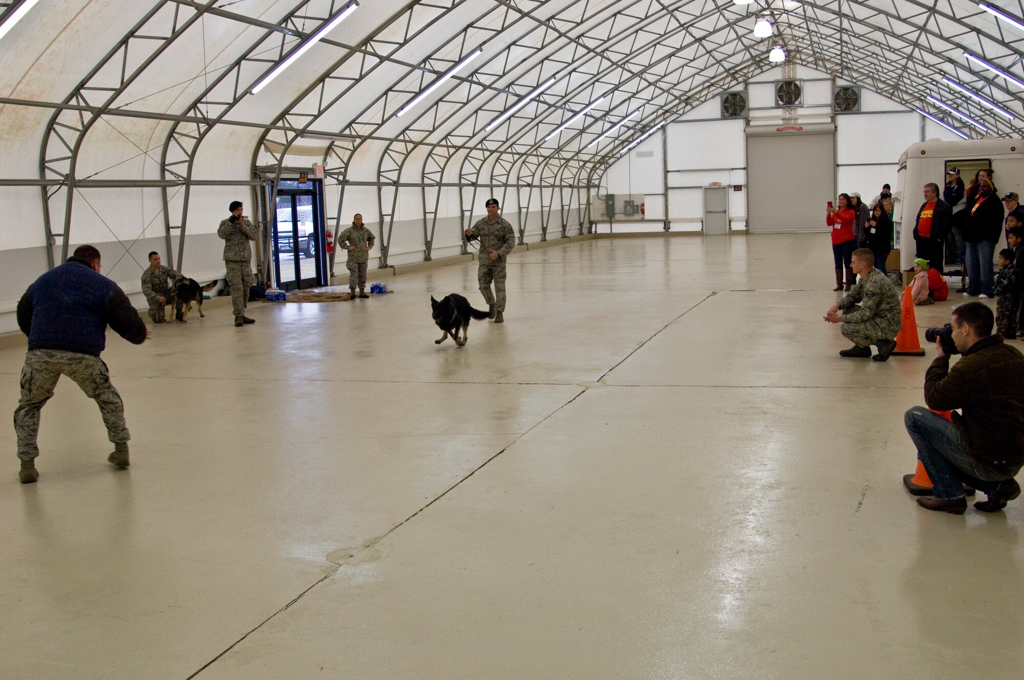 Citizens of the local community watch as members of the 4th Security Forces Squadron perform a demonstration during the annual Wayne County Woof Fest, Feb. 15, 2014, in Dudley, N.C.  Woof Fest is a yearly event for patrons to celebrate their love for dogs.  The event highlighted the different talents of “man’s best friend,” including the rigorous training of the military working dogs and their handlers.  (U.S. Air Force by Airman 1st Class Brittain Crolley)