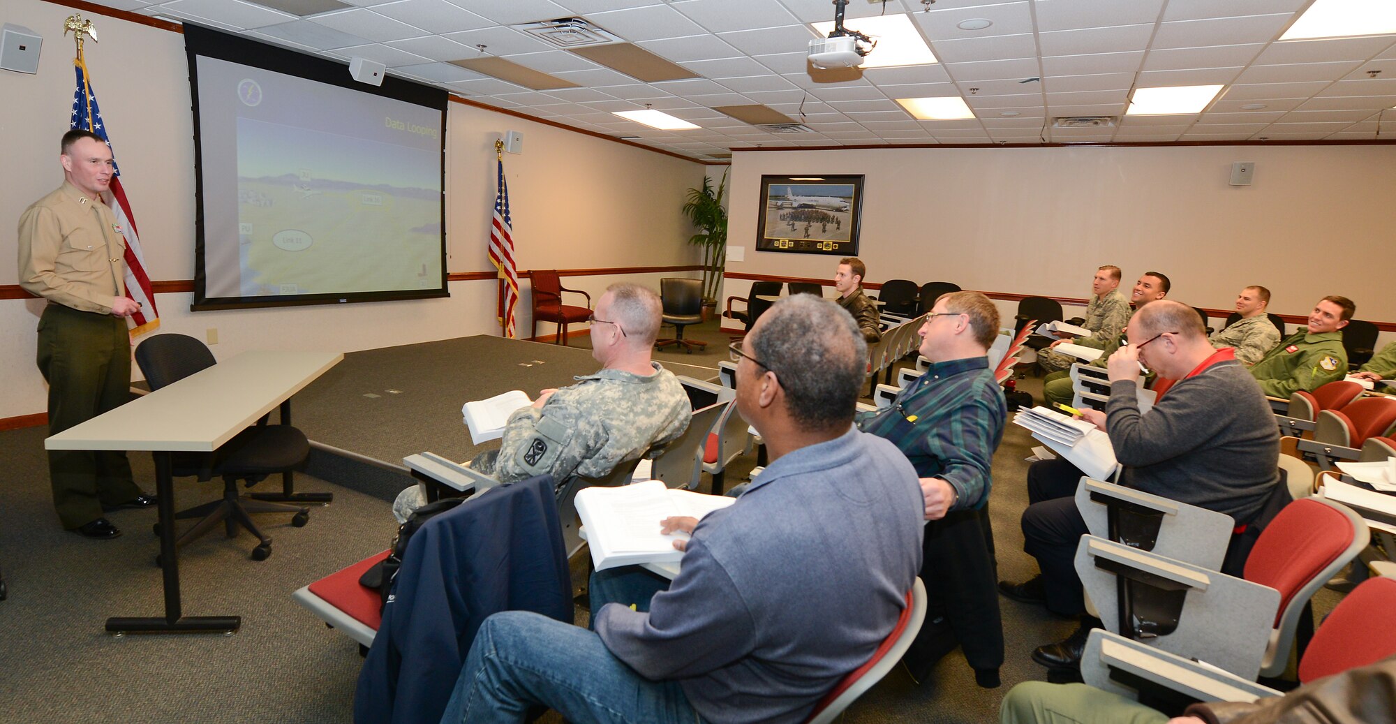 U.S. Marine Capt. James Phillips, an instructor with the Joint Multi-TDL School, teaches the JT-101 Multi-Tactical Data Link Network Operations Course conducted by the Joint Interoperability Division (JID) at Robins Air Force Base, Ga., Jan. 31, 2014. The five day course offered JSTARS operators and other personnel involved with Tactical Data Link networks the opportunity to hone their current skill sets and train on how to share vital command and control information and achieve full spectrum dominance through unity of command and effort. (U.S. Air National Guard photo by Master Sgt. Roger Parsons/Released)