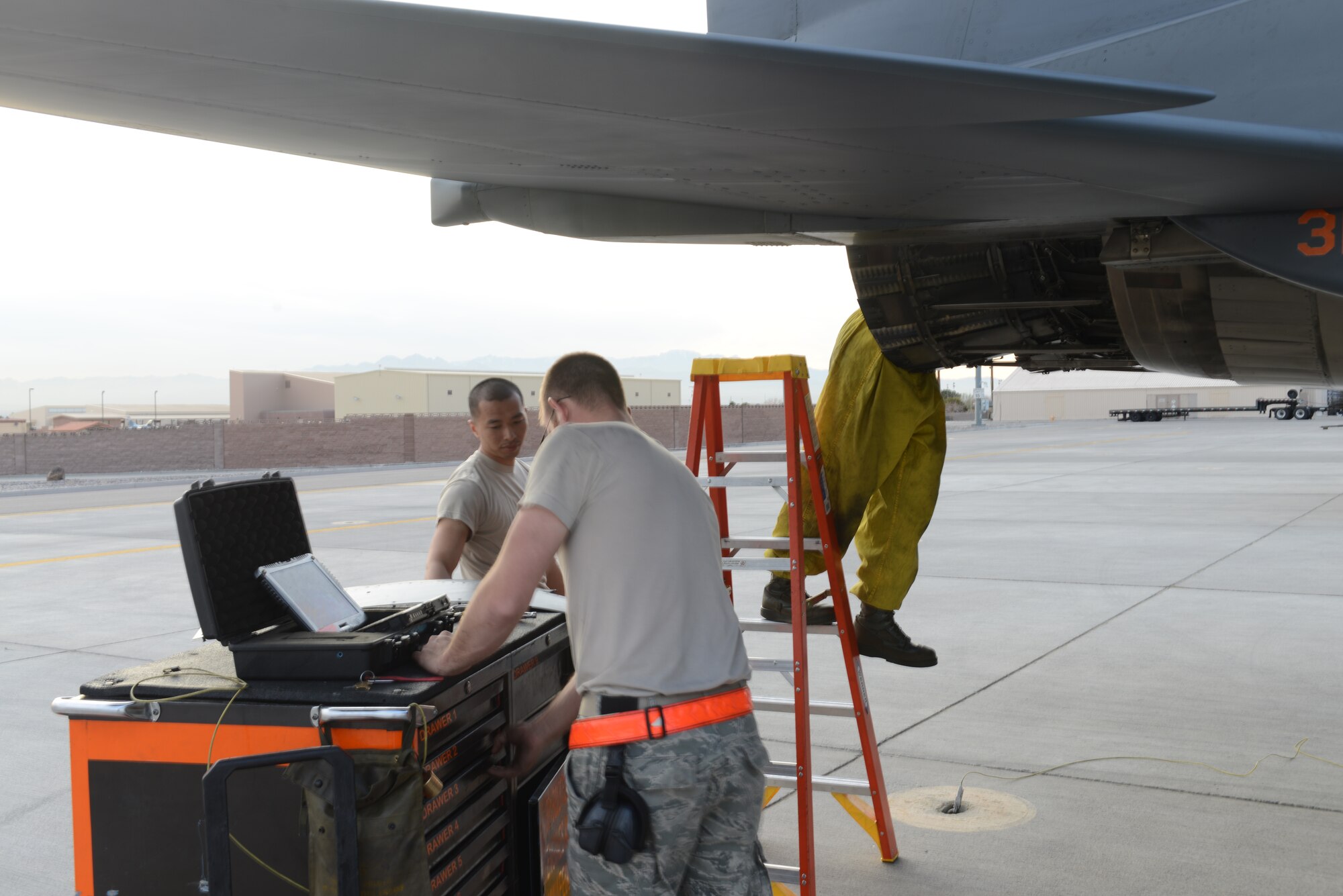 From left, Senior Airman William Le, 366th Aircraft Maintenance Squadron aerospace propulsion journeyman, Staff Sgt. Jacob Harvey, 366th AMXS aerospace propulsion craftsman, and Staff Sgt. Corey Covell, 366th AMXS crew chief, perform an inspection on the engine of an F-15E Strike Eagle Feb. 14, 2014, at Nellis Air Force Base, Nev. Intake inspections are completed before every flight to ensure an aircraft’s intake is clear of cracks and debris. (U.S. Air Force photo by Senior Airman Benjamin Sutton/Released) 