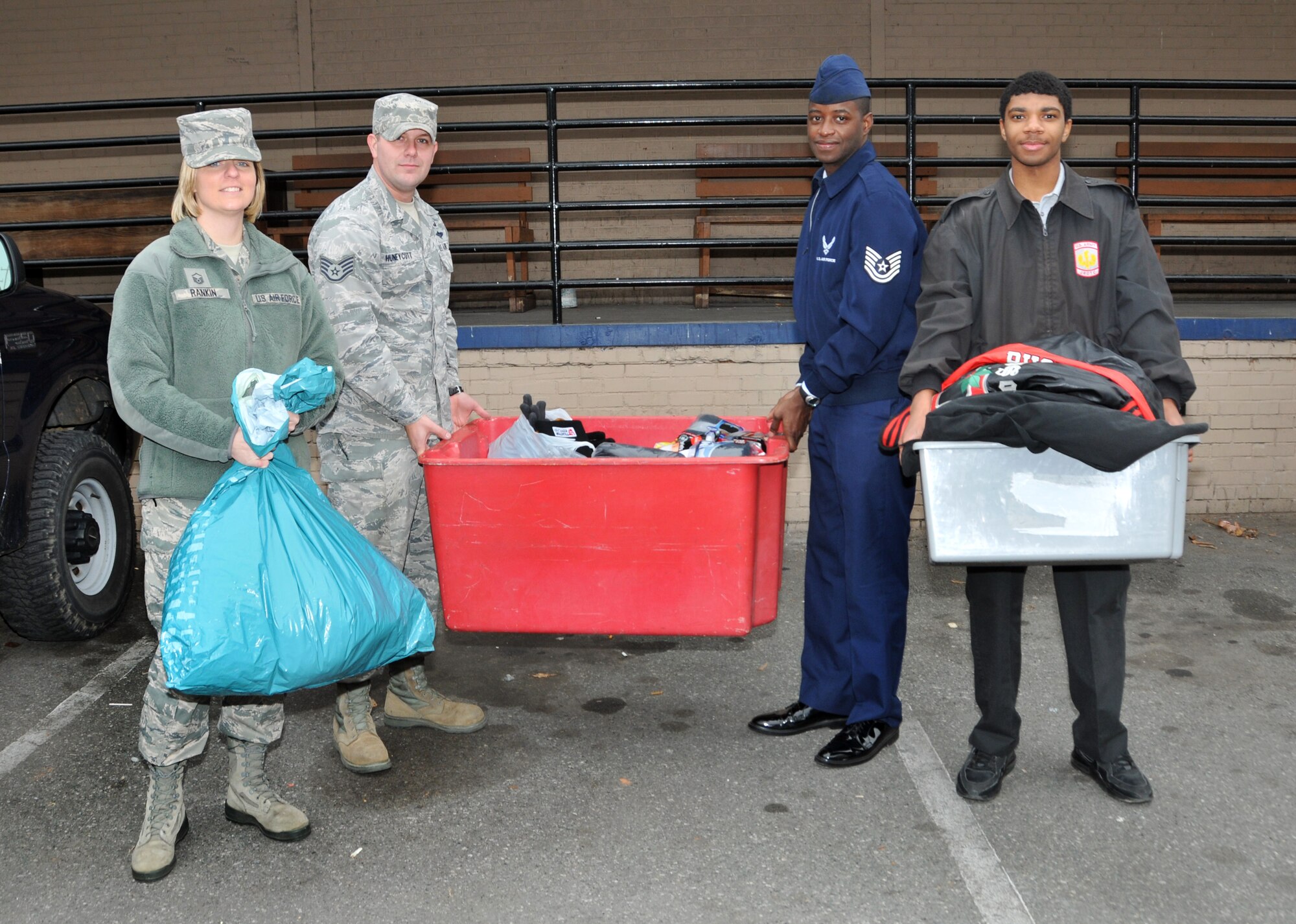 U.S. Air Force Master Sgt. Tracie Rankin, President of the 145th Airlift Wing’s Chapter 7 Association, Director at Large, Staff Sgt. Jessie Huneycutt, Vice President, Tech. Sgt. Lonnie Brooks and Gregory Landrum, a student from Military Global Leadership Academy get ready to deliver winter clothing donated by members of the North Carolina Air National Guard to a homeless shelter in Charlotte, N.C.  Men’s coats, hats, gloves and other items were collected by members of Chapter 7 and delivered to a local homeless shelter in Charlotte, N.C. just as a winter storm hits the Carolinas. (U.S. Air National Guard photo by Master Sgt. Patricia F. Moran/Released)  