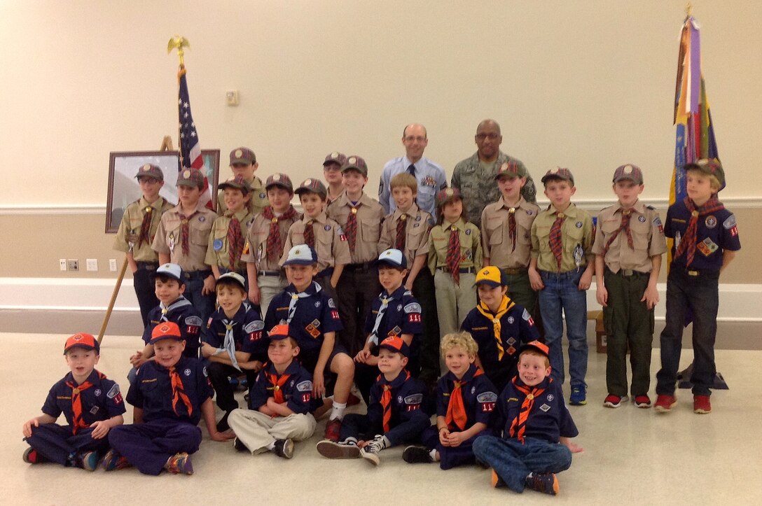 U.S. Air Force Senior Master Sgt. Kevin Drost, 245th Civil Engineering Flight and Senior Master Sgt. Gary Barber, 145th Force Support Squadron pose with scouts and leaders from Pack 116, a local Cub Scout troop, after accepted an invitation to speak at the scout’s meeting held February 4, 2014 in Matthews, N.C.  Speaking to such groups is a great opportunity to teach children tools to use in life and hear firsthand the importance they can bring to their community, state and nation. 