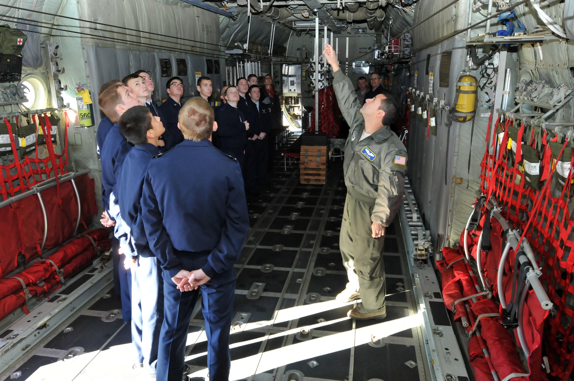 U.S. Air Force Capt. Paul Jay Allen, 156th Airlift Squadron, explains the principles and tactics of flight to Air Force JROTC cadets from Trinity High School as they tour a 145th Airlift Wing, C-130 Hercules aircraft at the North Carolina Air National Guard base, Charlotte Douglas Intl. airport, December 12, 2014.  Providing tours to these cadets is one way the NCANG gives back to the community.  These young adults want to make a change in the community and have an impact on the world.  They understand the importance of the military.  The NCANG provides them an opportunity to see firsthand the importance of the sacrifices that have been made in the past, and what it takes to continue to do well in the future.  (U.S. Air National Guard photo by Master Sgt. Patricia F. Moran/Released) 