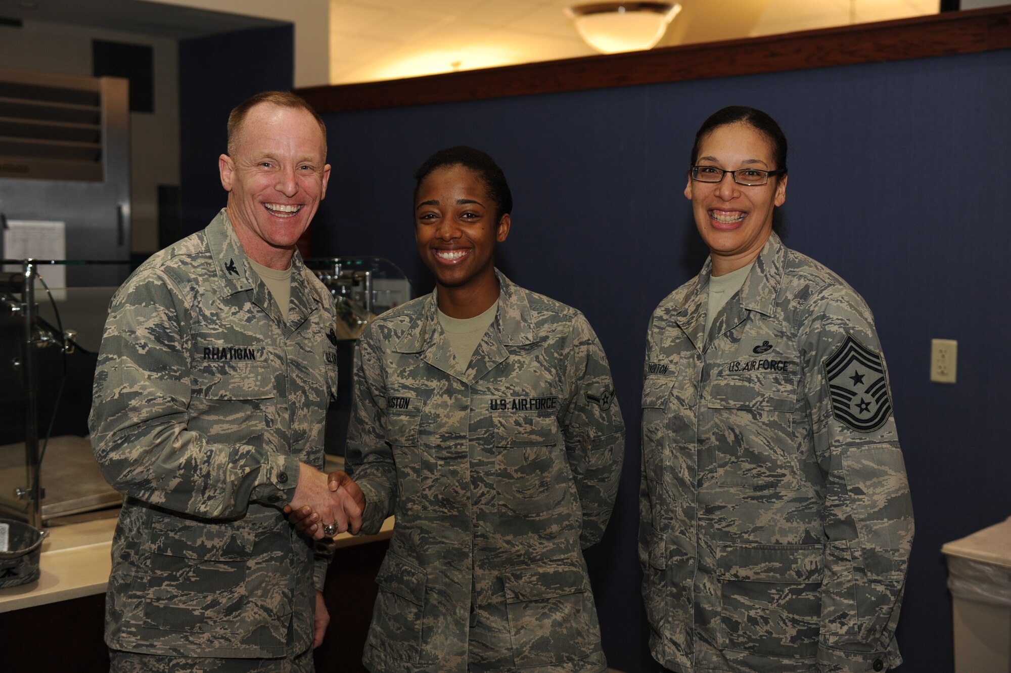 Col. Patrick Rhatigan, 19th Airlift Wing commander, along with Chief Master Sgt. Margarita Overton, 19th Airlift Wing command chief, congratulate Airman Kathryn Huston, a 19th Force Support Squadron food service apprentice, for her selection as Combat Airlifter of the Week, Feb. 18, 2014, at Little Rock Air Force Base, Ark. Huston serves 700 meals daily to support more than 5,500 Airmen, families and retirees through the Air Force’s newest Food Transformation Initiative. (U.S. Air Force photo by Airman 1st Class Cliffton Dolezal)