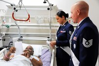Staff Sgt. Kathryn North and Tech. Sgt. Daniel Anderson, 2014 Joint Base San Antonio Air Force military ambassadors,speak with Army veteran Alvo Tucker Jr. during the 2014 National Salute to Veteran Patients program Feb. 14 at Audie Murphy VA Hospital in San
Antonio. The military ambassadors and Joint Base San Antonio military leaders distributed valentines and visited with veteran patients. (U.S. Air Force photo by Airman 1st Class Alexandria Slade)