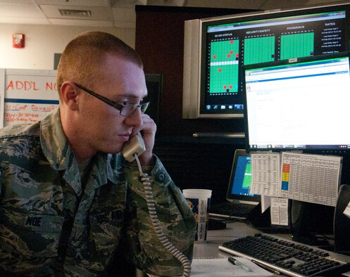 Senior Airman Phillip Noe, 90th Maintenance Operations Squadron Missile Maintenance Operations Center technician, answers a phone call in the MMOC, which is located in the basement of Building 232 where he and other MMOC technicians coordinate maintenance activities in the 90th Missile Wing’s missile complex, Feb. 14, 2014. (U.S. Air Force photo by Airman 1st Class Jason Wiese)